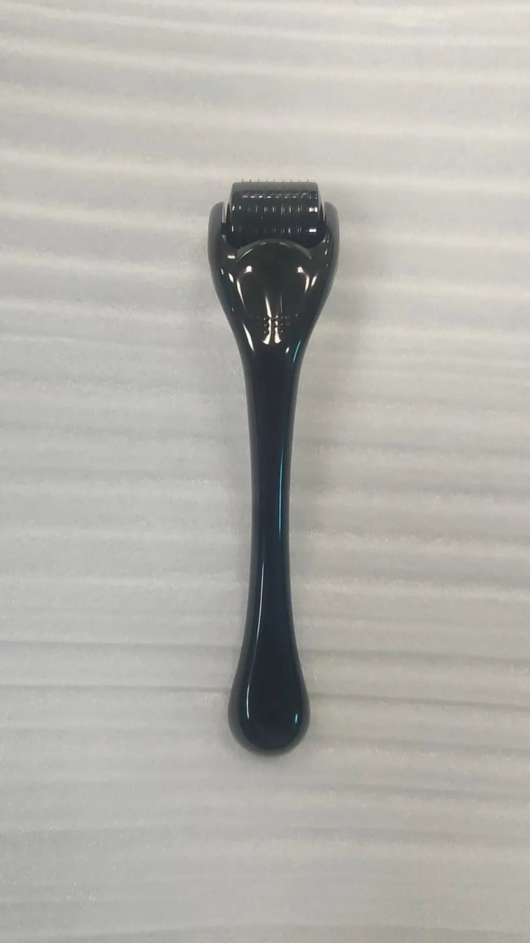 Professional 540 needle dermaroller for mechanical font with coloured handle and wheel, showing sterile stainless steel needles.