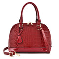 Large shiny black PU leather crossbody shoulder bag showing shell-shaped structure.
