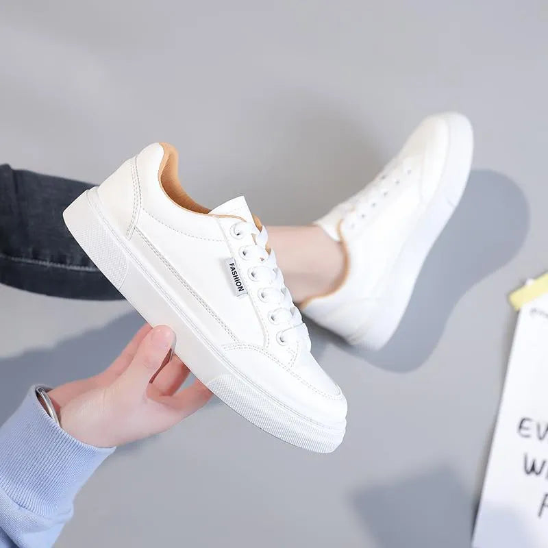 Korean style low-top women's sneakers in white and brown, showing artificial PU upper and plastic sole