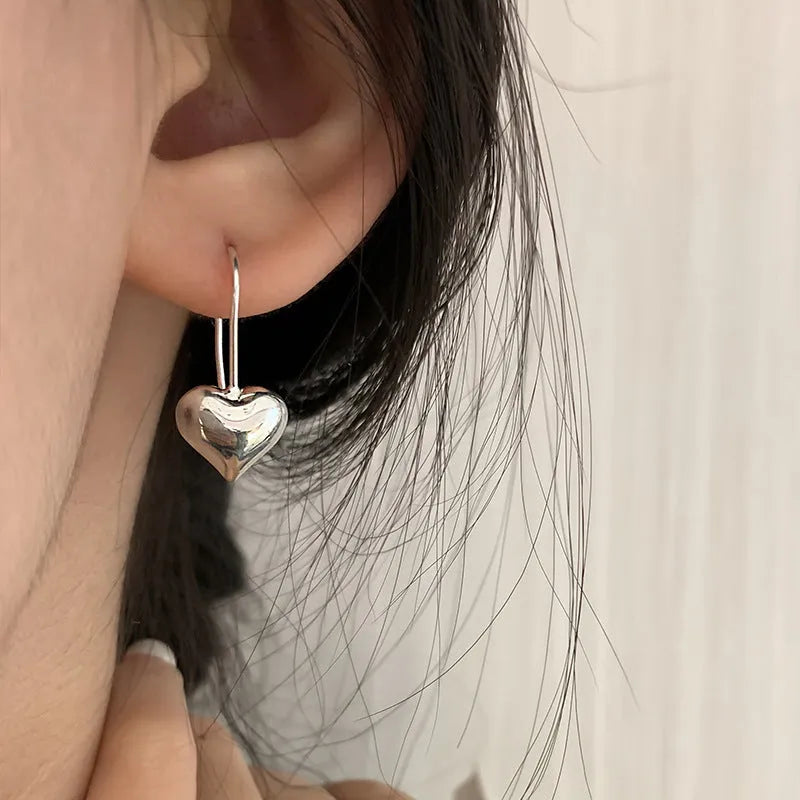 Silver-coloured heart-shaped earrings with 3D glossy design and Korean-style elements