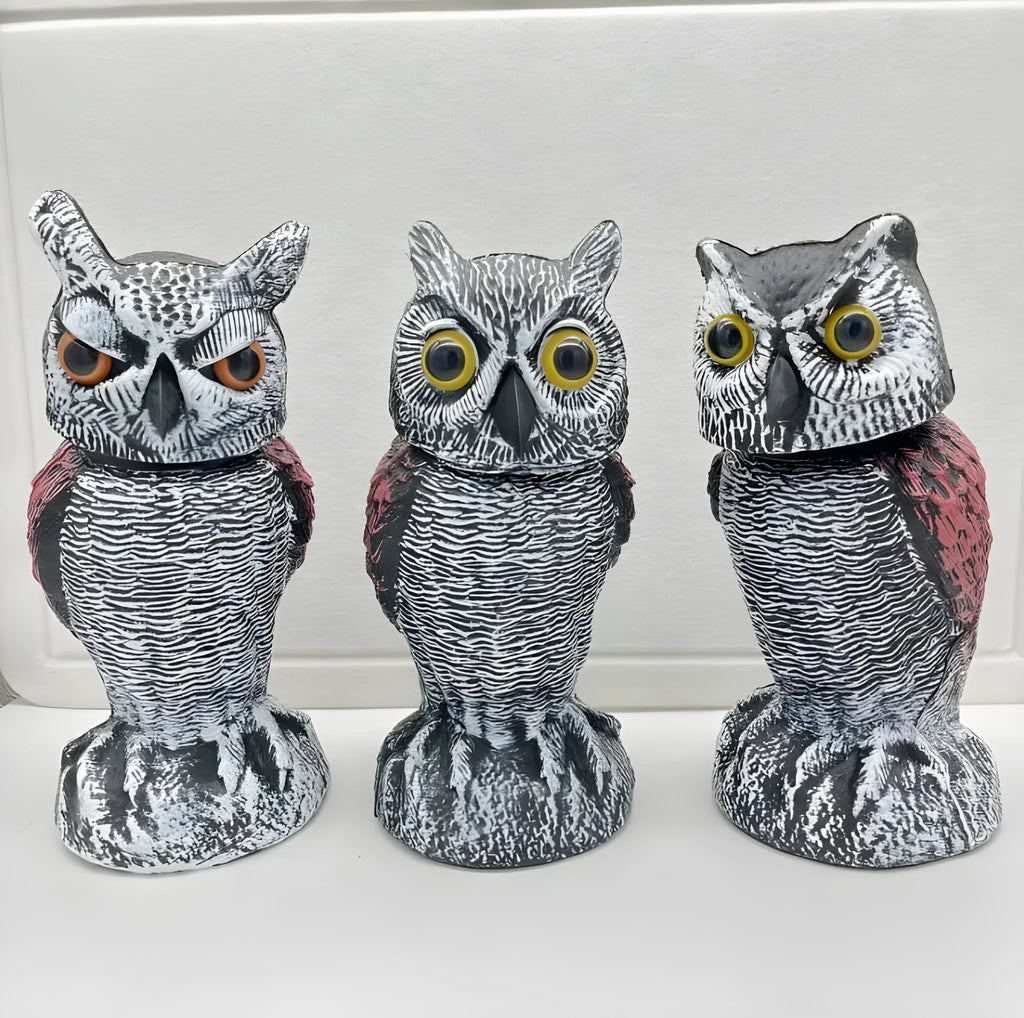 Artificial owl bird deterrent ornament with moving head in outdoor setting
