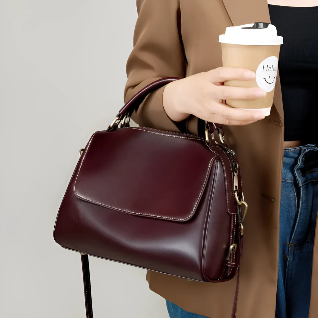 Women's genuine leather crossbody tote bag in apricot colour with double straps and outer slit pocket.