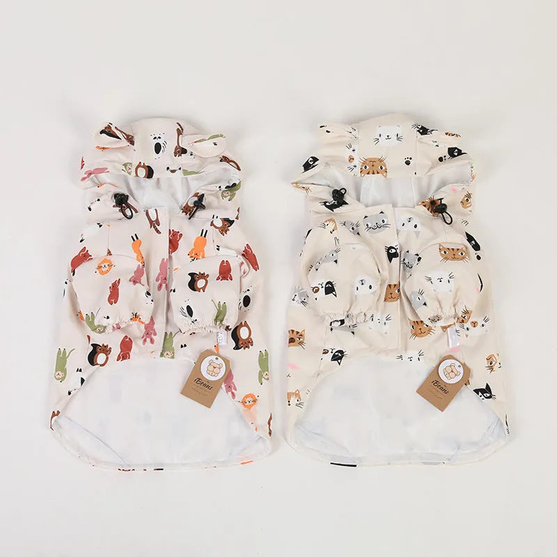 Beige dog raincoat with cartoon cat head pattern, showing waterproof PU material