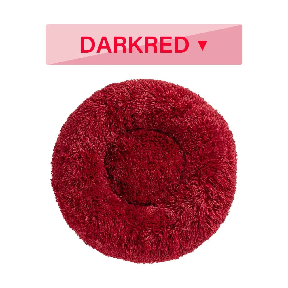 Fluffy grey donut dog bed with raised rim, shown with a small dog sleeping inside.