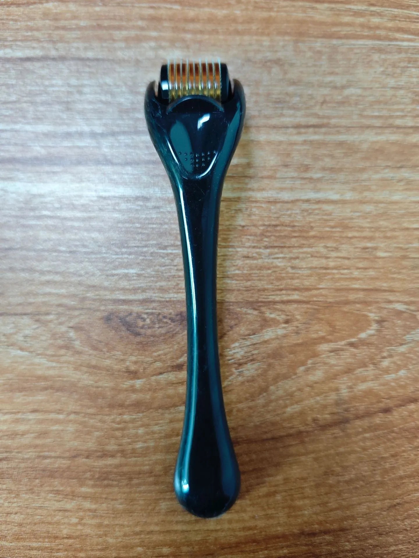 Professional 540 needle dermaroller for mechanical font with coloured handle and wheel, showing sterile stainless steel needles.