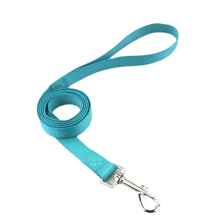 Solid colour polyester dog lead held in a hand, showing one of eleven colour options and its single rope construction.