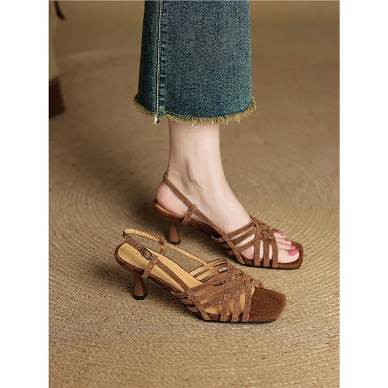 Retro soft brown women's sandals with thin cross straps, a mid-heel, and an ankle buckle on a white background.