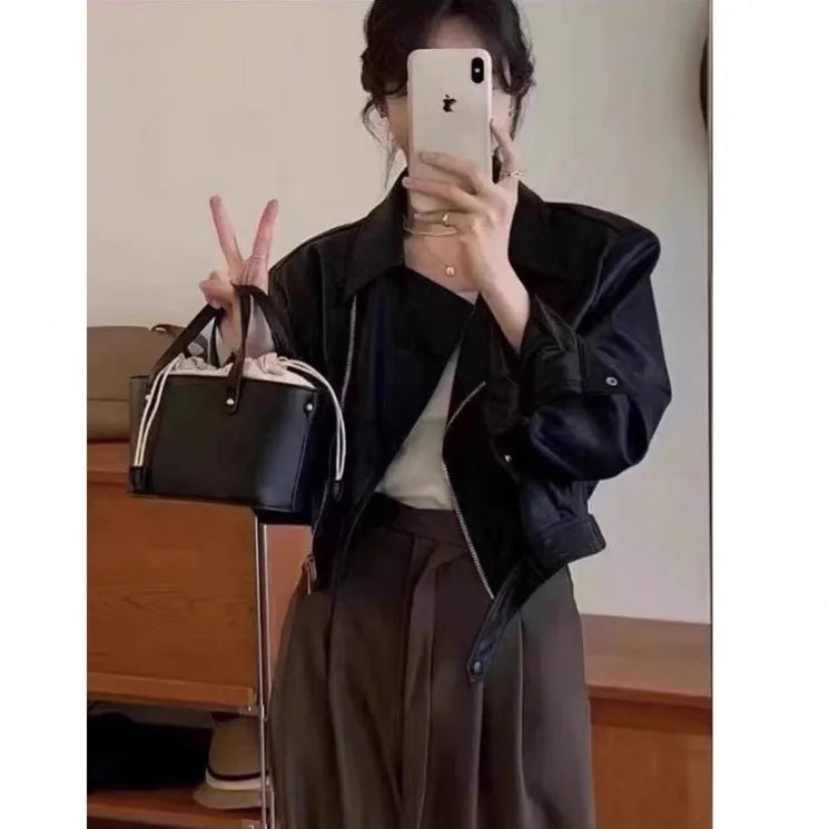 Women's slim fit leather coat jacket in black with long sleeves and pockets