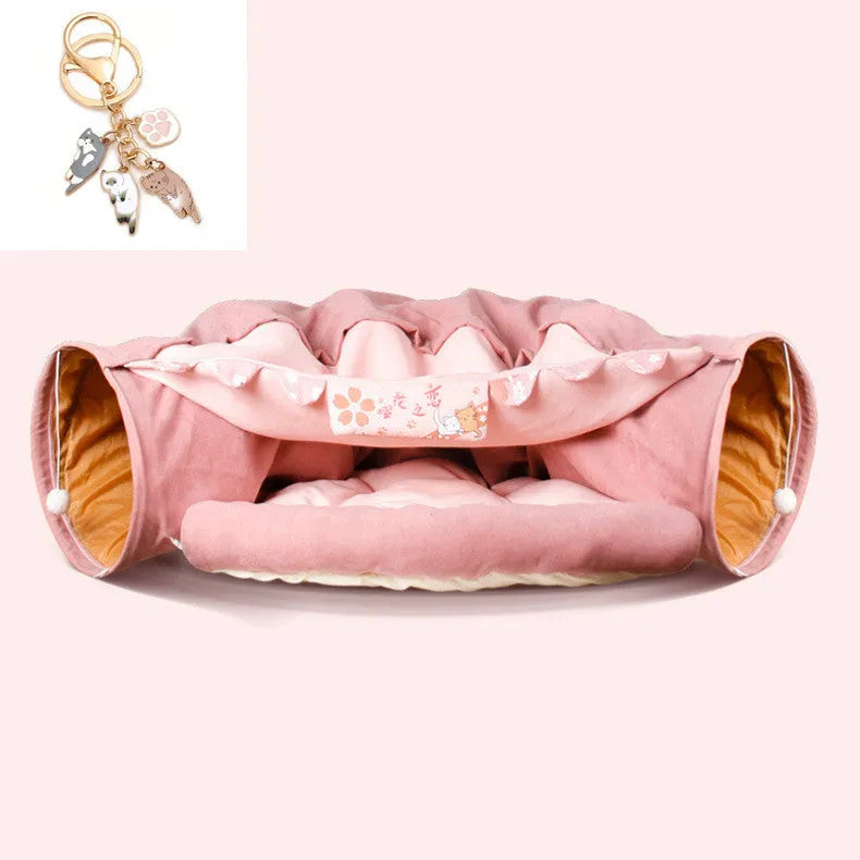 Collapsible cloth cat tunnel folded flat next to a cat, showing Coffee colour option.