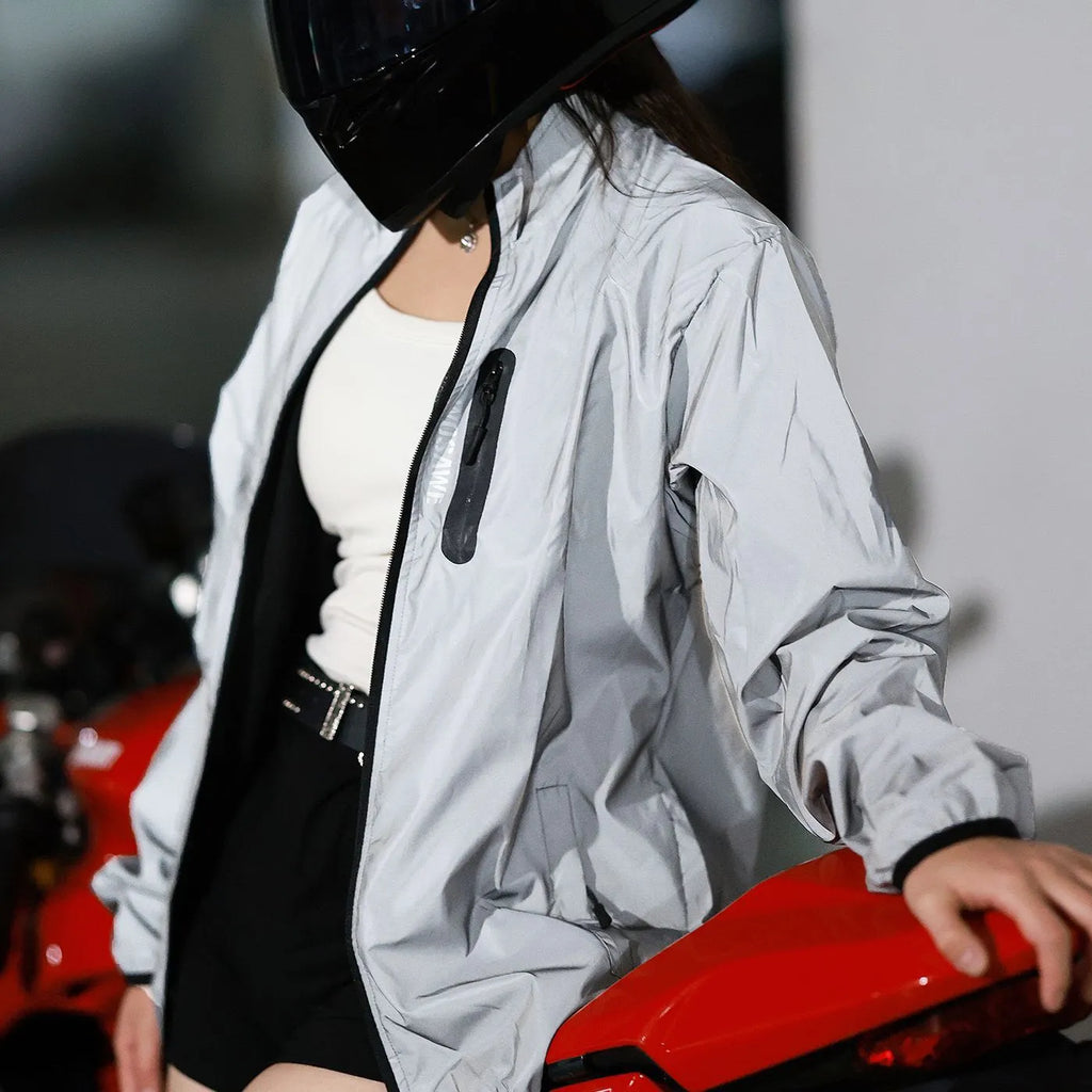 Silver coloured waterproof polyester long sleeve jacket for men on a hanger.