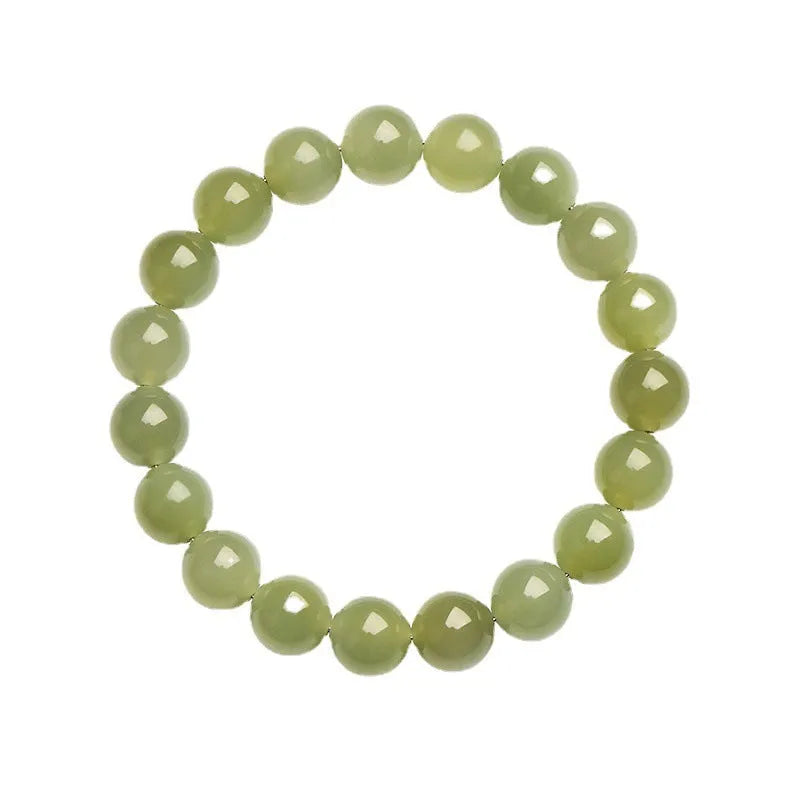 Polished Hetian Jade ball bead bracelet in deep clear water colour on a wrist.