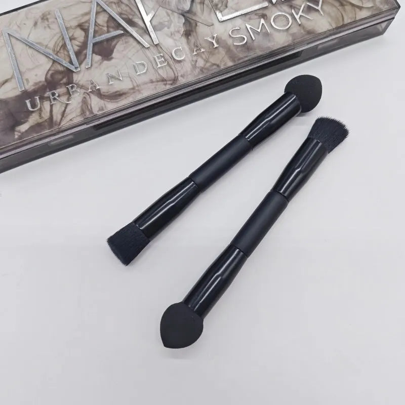 Elegant black double-headed makeup brush with a concealer brush and angled miter sponge on a wooden handle.