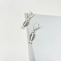 Silver-colour fishbone pendant necklace with O-chain and matching earrings on grey background