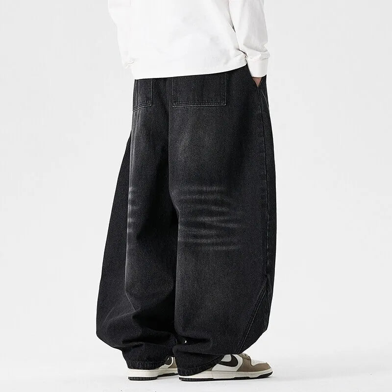 Men's plus size light blue wide leg baggy denim jeans with a low waist and straight leg opening.