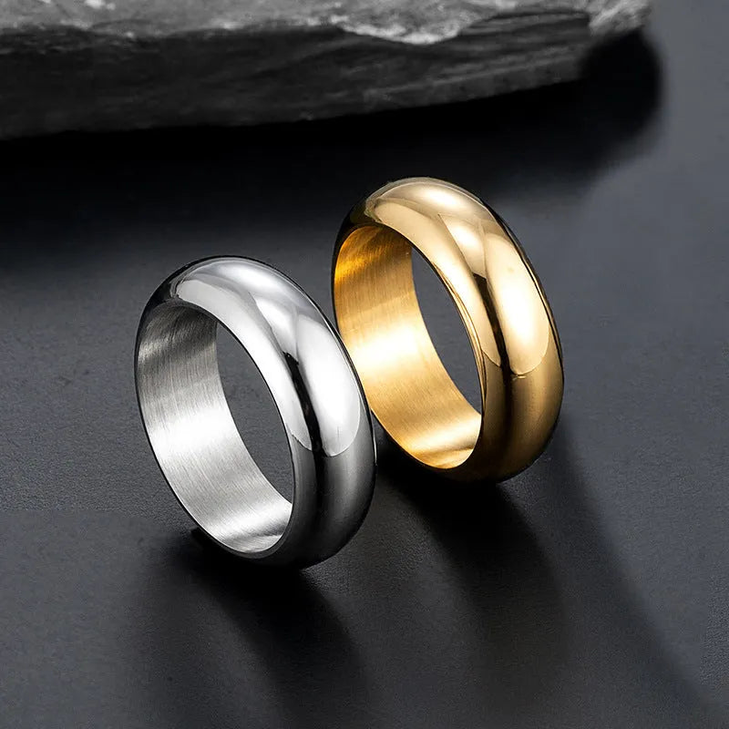 Glossy electroplated titanium steel ring shown in gold, black, and steel colour options on a plain background.