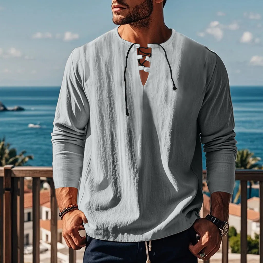 Cotton linen beach ruff shirt in a loose pullover style on a hanger.