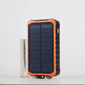 Orange and green hand crank solar power bank with 12000mAh capacity, dual USB ports, and a solar panel.