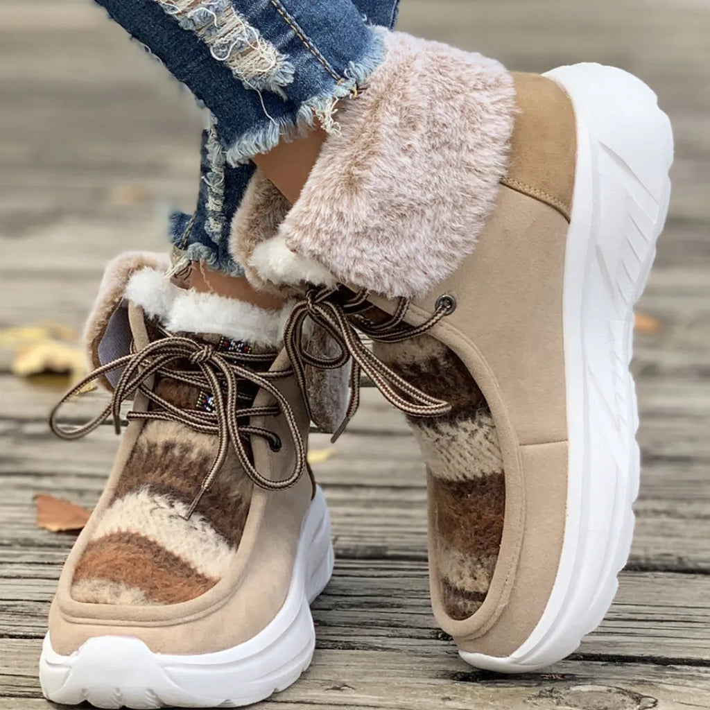Women's beige lace-up snow boots showing front tie design and mid-top height with plush lining