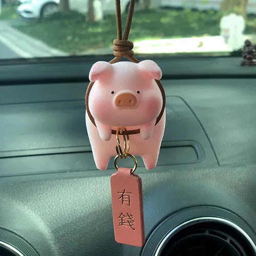 Colourful 3D resin cartoon pig figurine car decoration on a car dashboard