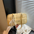 Structured PU leather single-shoulder flap bag in a horizontal square shape with a flap closure.