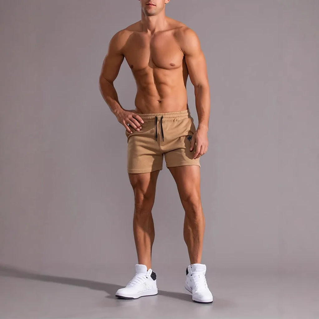 Khaki men's sports shorts with a white coconut leaf print, showing straight leg fit.