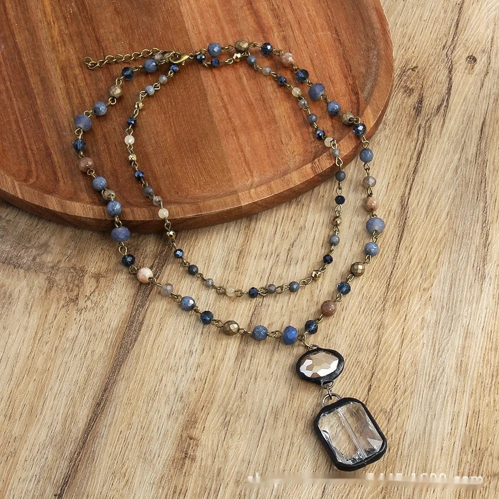 Tribal style two-layer chain necklace with glass and stone pendants in beige and blue colours