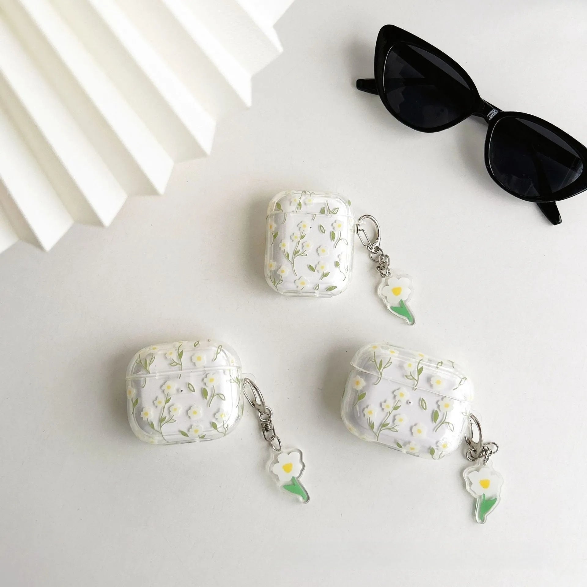 Transparent TPU AirPods case cover with white floral design showing compatibility with multiple Apple AirPods models