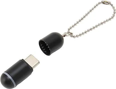 Black capsule-shaped infrared emitter with Lightning, Type-C and Micro-USB interfaces, shown next to a ruler for scale.