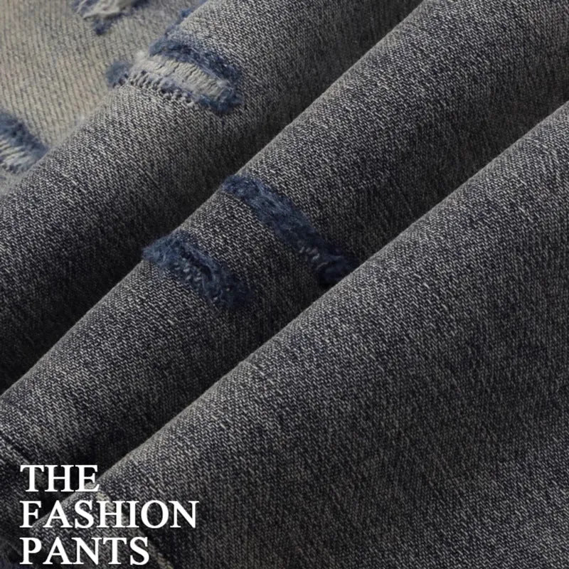Distressed slim fit jeans with embroidered patches and washed-out vintage colour
