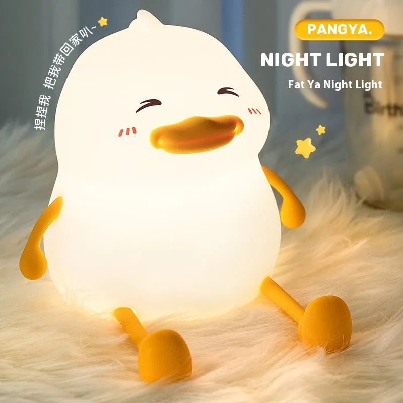 Chubby Night Light desk lamp showing soft glow, phone holder slot, and compact silicone design.