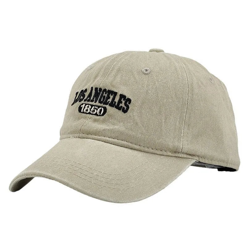 Retro personalised embroidered washed distressed peaked cap in beige with an adjustable strap.
