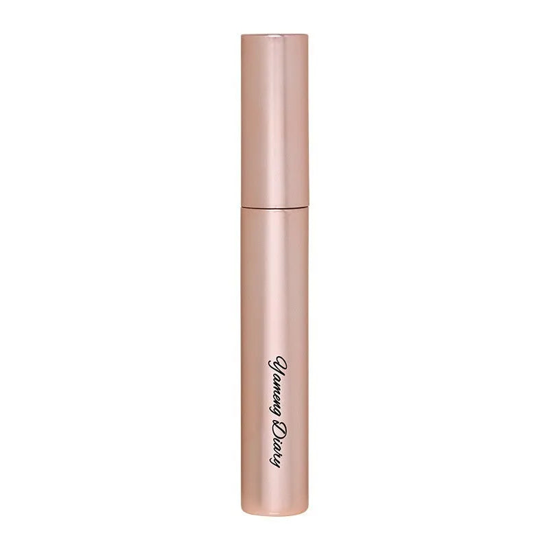 Black mascara tube with brush applicator for curling and volumising lashes