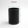 Black leather round pen holder with cylindrical shape on a desk