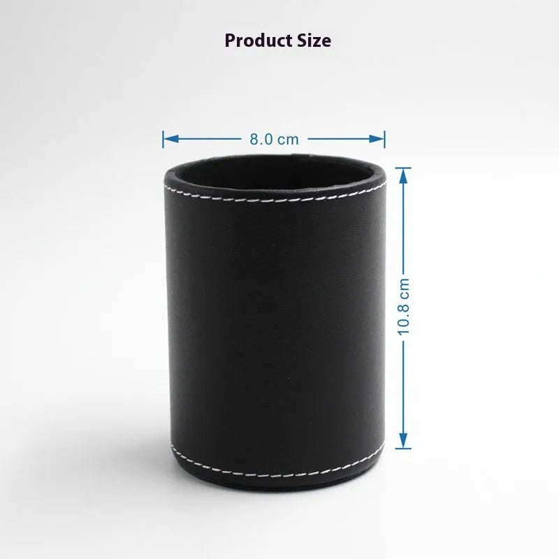 Black leather round pen holder with cylindrical shape on a desk