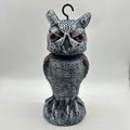 Artificial owl bird deterrent ornament with moving head in outdoor setting