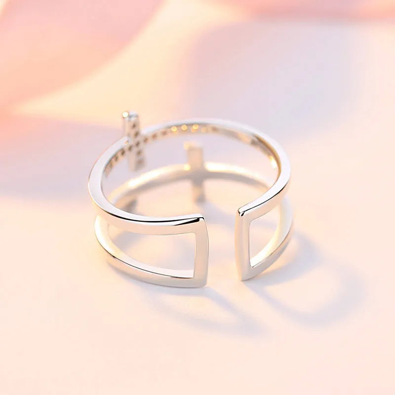 Women's adjustable copper ring with a double cross design and sparkling zircon inlays.