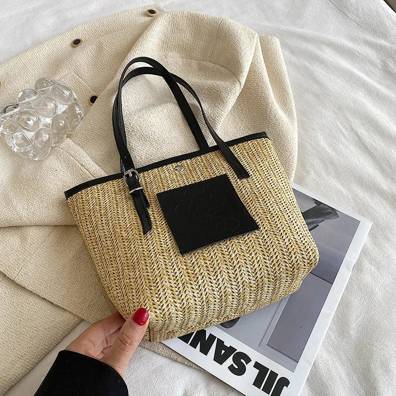 Straw woven women's shoulder bag with 27cm width showing three-dimensional pocket and 18cm handle