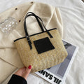 Straw woven women's shoulder bag with 27cm width showing three-dimensional pocket and 18cm handle