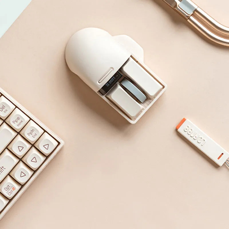 Xiaoqiao tofu-colour wireless mouse showing seven buttons and scroll wheel on desktop