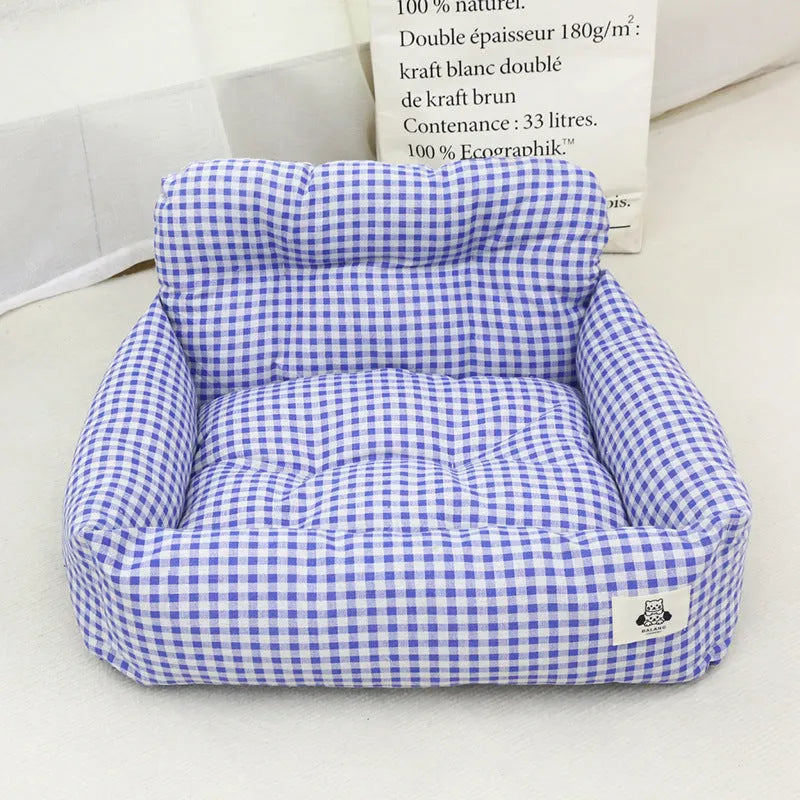 Car-mounted pet carrier nest in blue plaid cloth for dog transport