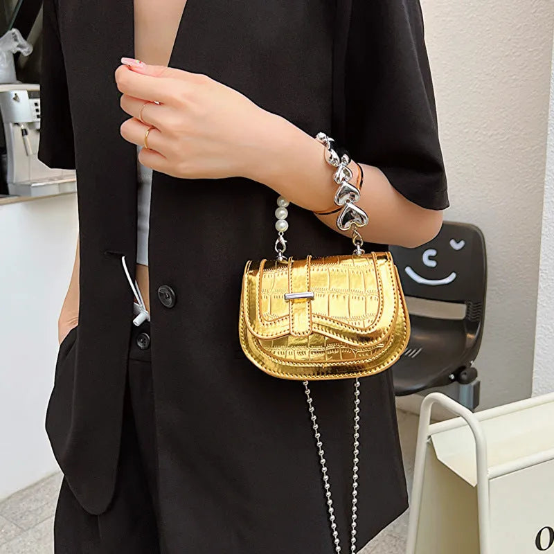 Silver square women's crossbody bag with single shoulder strap showing internal phone pocket
