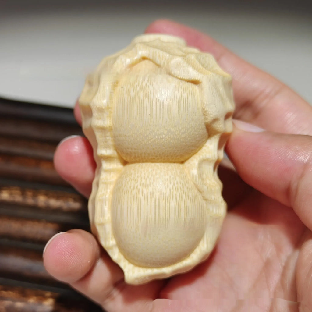 Solid natural bamboo peanut ornament with 'good things may happen' engraved message.