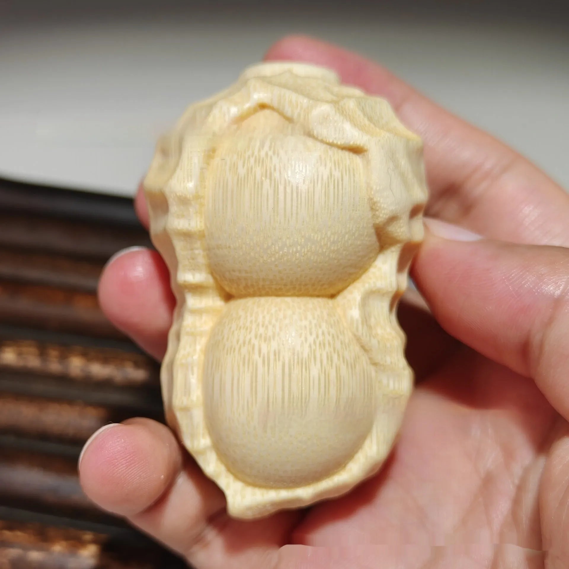 Solid natural bamboo peanut ornament with 'good things may happen' engraved message.