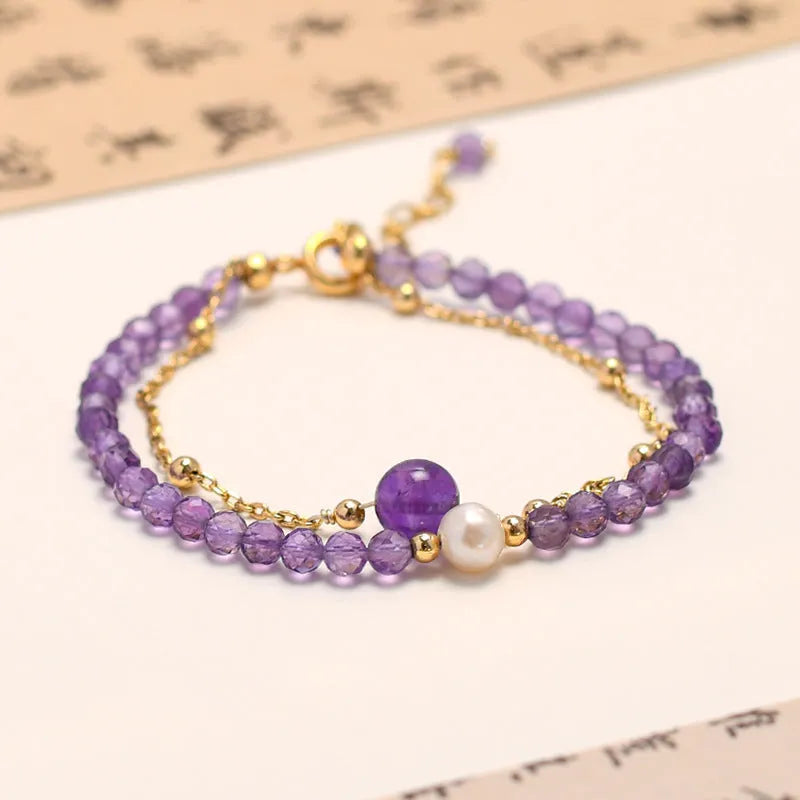 Close-up of a women's amethyst crystal bracelet with a diamond shape and Chinese style design.