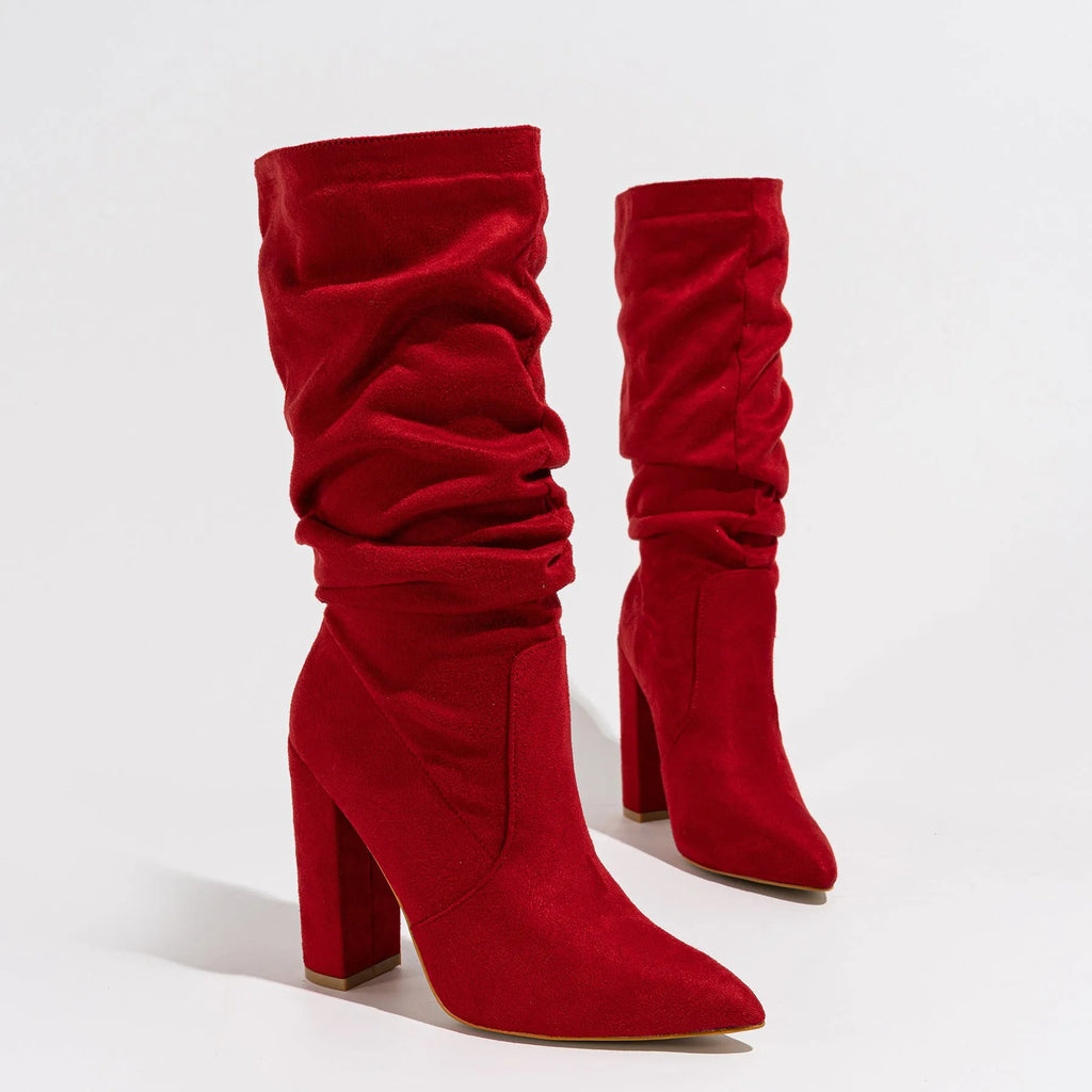 Black suede women's boots with a pointed toe and a thick chunky high heel, mid-calf length.