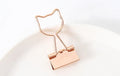 Gold metal decorative paper clip showing flamingo, love, cloud, cat, cactus, and bow shape options.