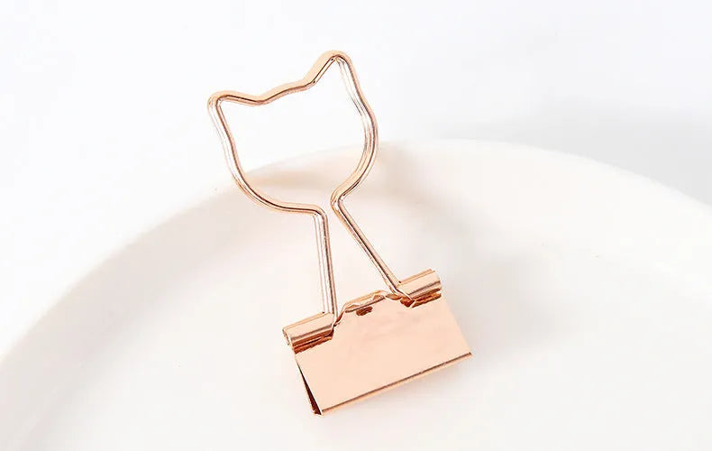 Gold metal decorative paper clip showing flamingo, love, cloud, cat, cactus, and bow shape options.