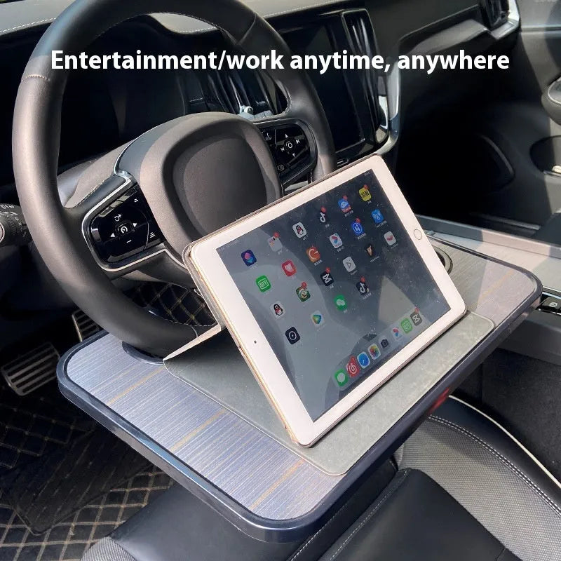 Large black ABS car steering wheel laptop stand with integrated foldable cup holder, mounted on a car steering wheel.