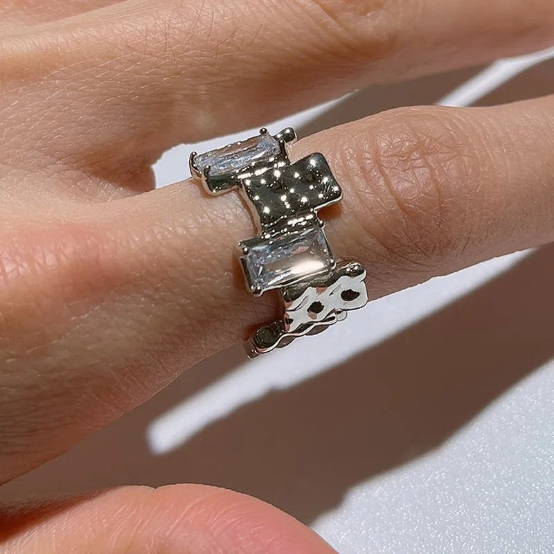 Silver geometric cross zircon ring with open gemstone design and three-dimensional decoration