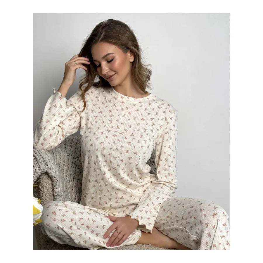 White floral print women's sleepwear set with long bell sleeve top and wide-leg trousers.
